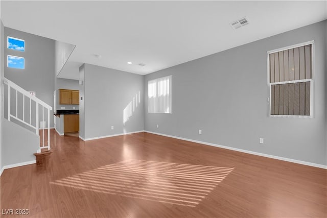 unfurnished living room featuring hardwood / wood-style floors