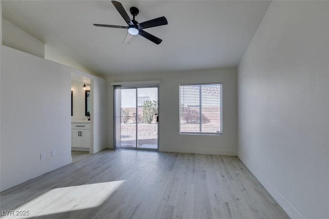 unfurnished room with ceiling fan, vaulted ceiling, and light hardwood / wood-style flooring