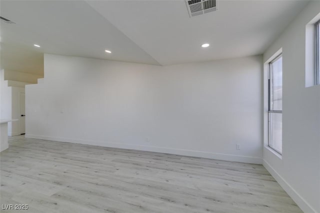 spare room featuring light wood-type flooring