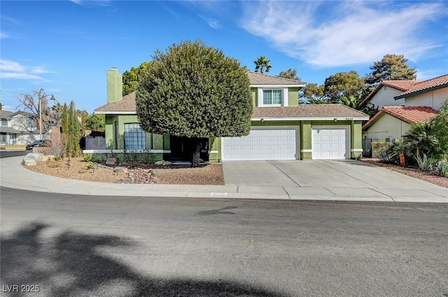 view of property hidden behind natural elements featuring a garage