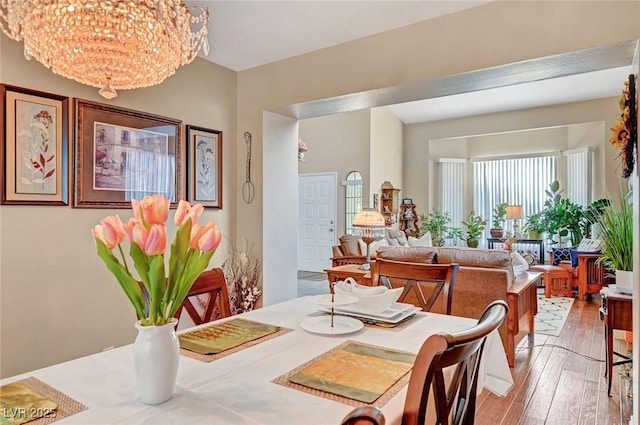 dining area featuring a notable chandelier and light hardwood / wood-style floors