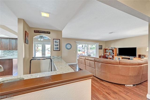 living room featuring french doors and light hardwood / wood-style floors