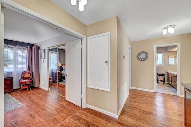 corridor with light hardwood / wood-style floors