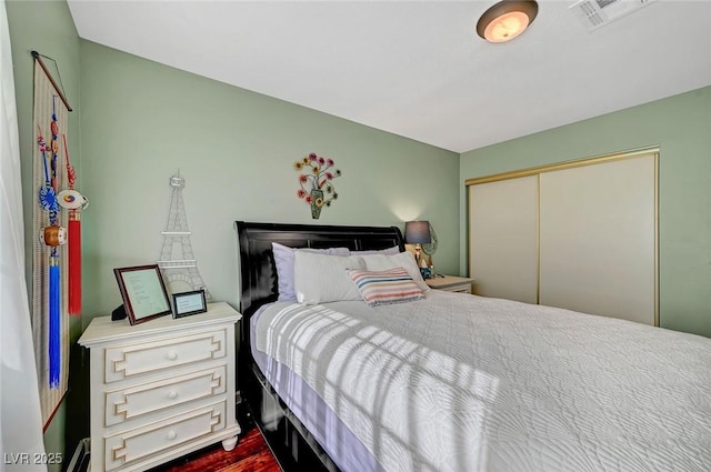 bedroom featuring hardwood / wood-style flooring and a closet