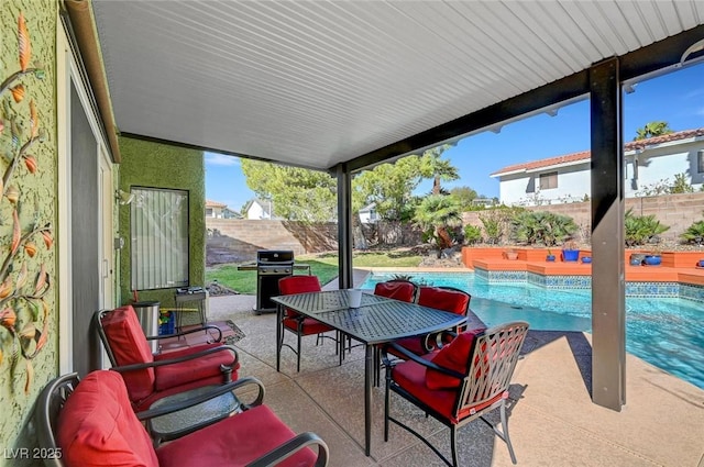 view of patio featuring a fenced in pool and a grill