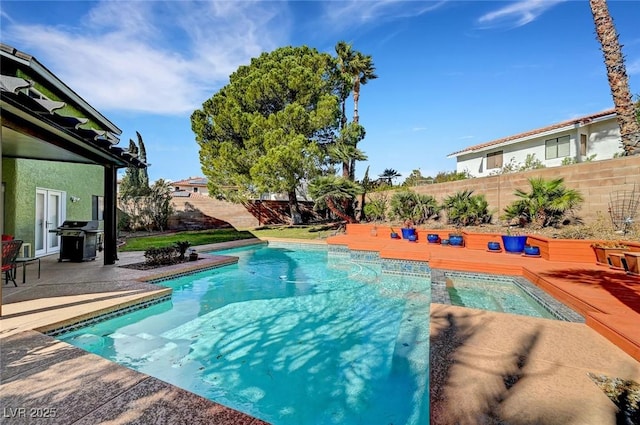 view of swimming pool featuring grilling area, a patio, and an in ground hot tub