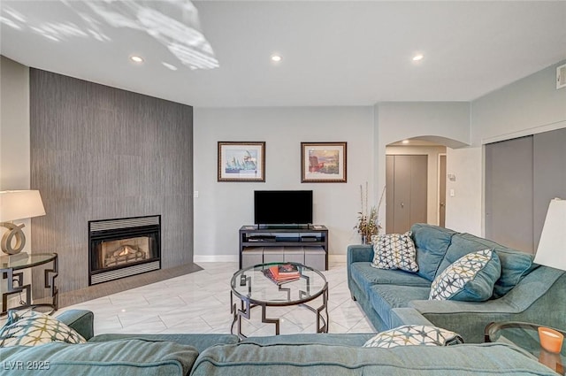 living room featuring a large fireplace