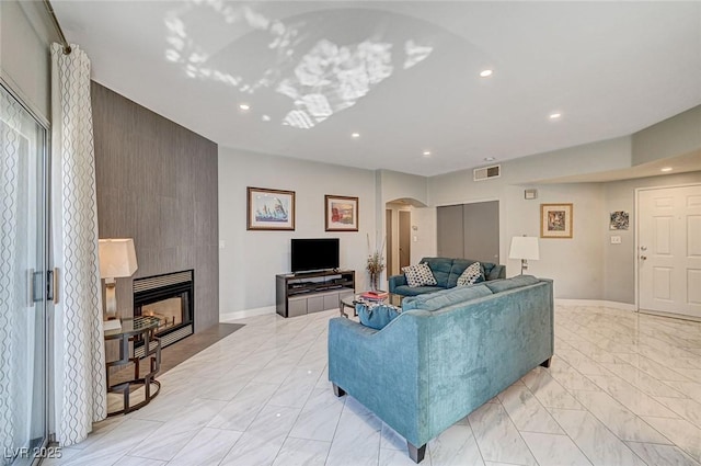 living room featuring a tile fireplace