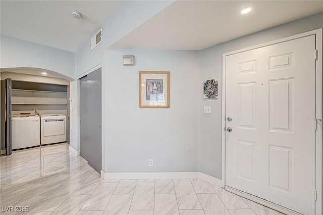 foyer entrance featuring independent washer and dryer