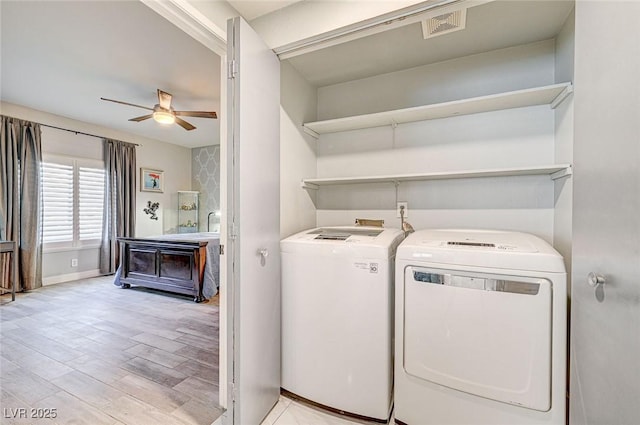 laundry room featuring separate washer and dryer, ceiling fan, and light hardwood / wood-style flooring