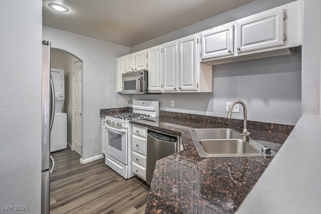 kitchen featuring a sink, baseboards, white cabinets, appliances with stainless steel finishes, and dark wood finished floors