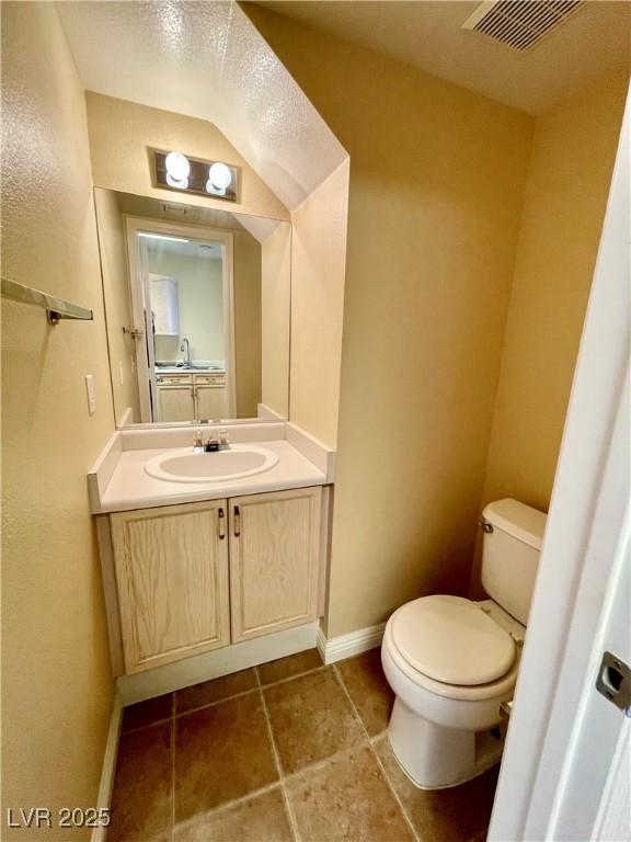 bathroom with vanity, tile patterned floors, and toilet