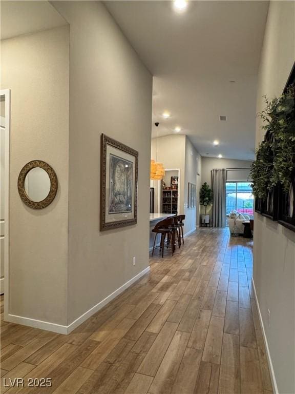 hallway with hardwood / wood-style flooring