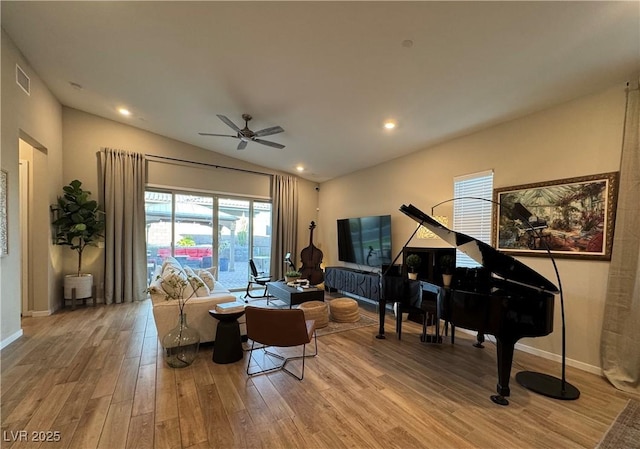 sitting room featuring ceiling fan, lofted ceiling, and light wood-type flooring