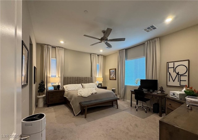 bedroom featuring multiple windows, light colored carpet, and ceiling fan