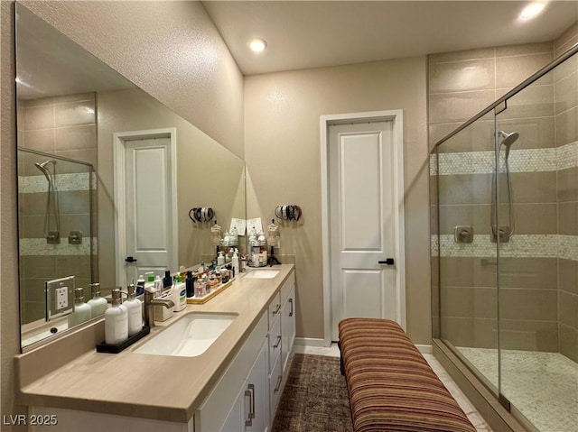 bathroom featuring vanity and a shower with door