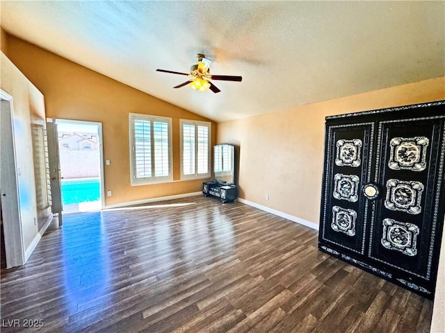 interior space featuring lofted ceiling, dark hardwood / wood-style flooring, and ceiling fan