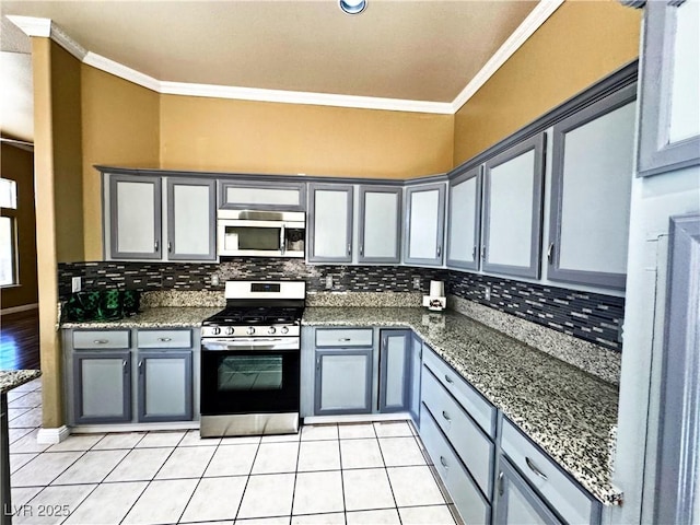 kitchen featuring tasteful backsplash, ornamental molding, and appliances with stainless steel finishes