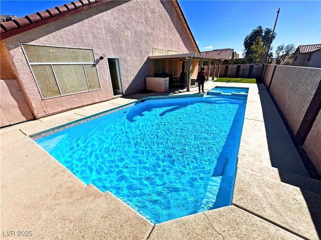 view of swimming pool with a patio