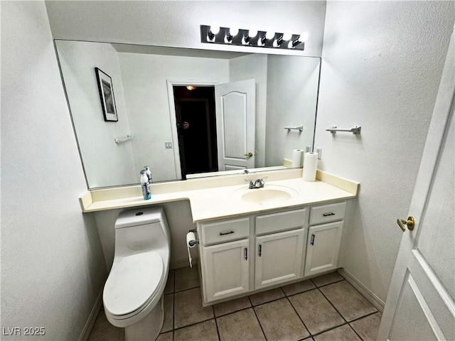 bathroom with vanity, tile patterned floors, and toilet