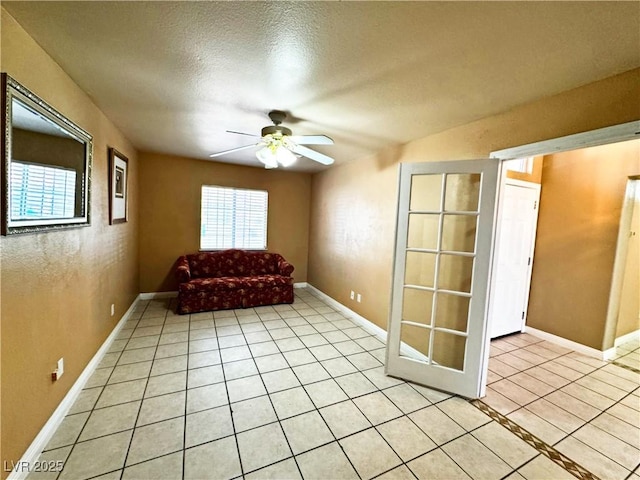 unfurnished room with light tile patterned floors, a textured ceiling, and ceiling fan