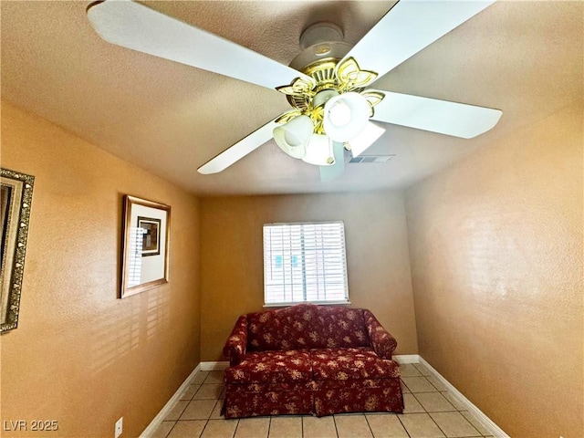 sitting room featuring light tile patterned floors and ceiling fan