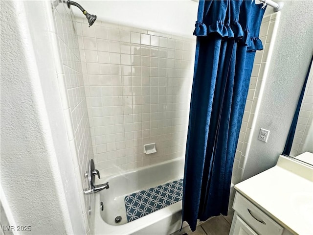 bathroom featuring shower / bathtub combination with curtain and vanity