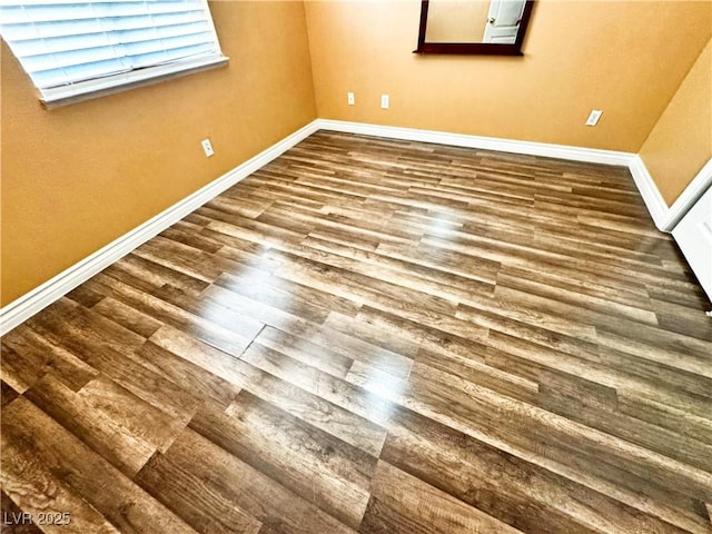 empty room with hardwood / wood-style flooring