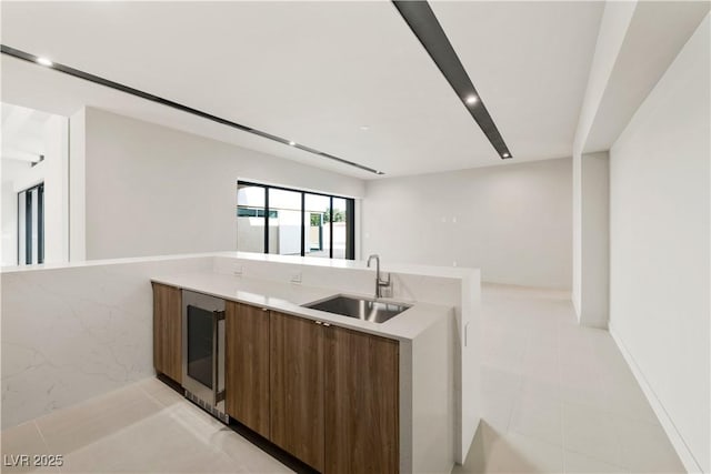 kitchen with sink, wine cooler, and kitchen peninsula