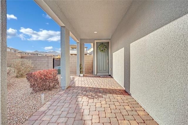 view of exterior entry with a patio area