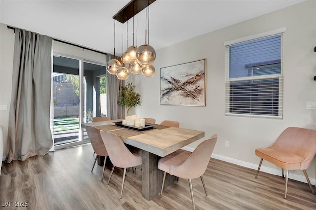 dining area featuring a chandelier and light hardwood / wood-style flooring