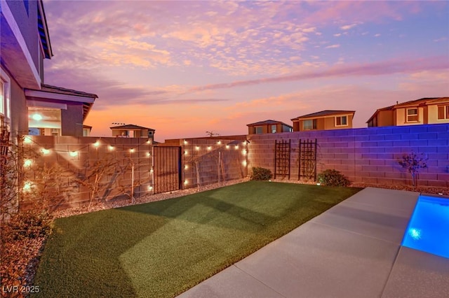 yard at dusk with a patio area