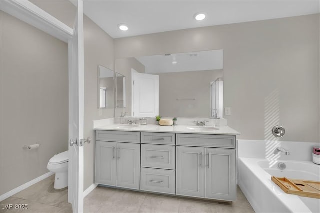 bathroom with vanity, toilet, and a bath