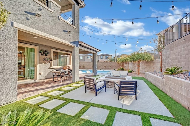 view of patio / terrace featuring a fenced in pool and an outdoor living space with a fire pit