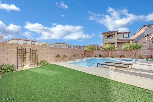 view of swimming pool featuring a yard and a patio