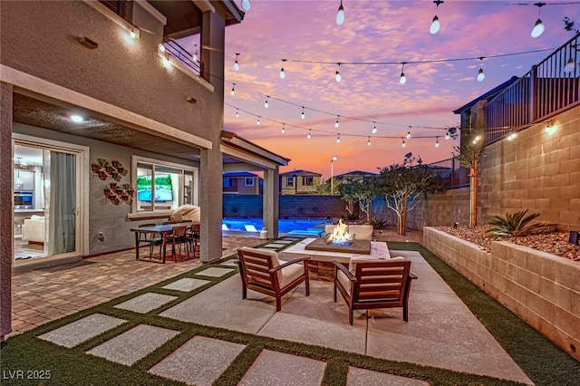 patio terrace at dusk with an outdoor fire pit