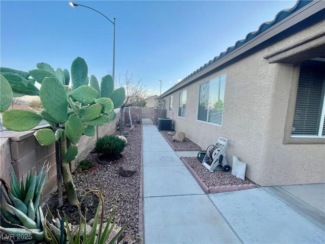 view of side of home featuring central AC and a patio area