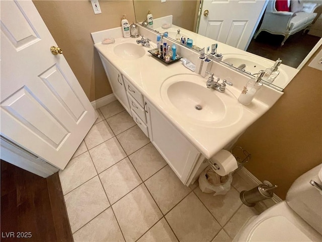 bathroom with vanity, tile patterned floors, and toilet