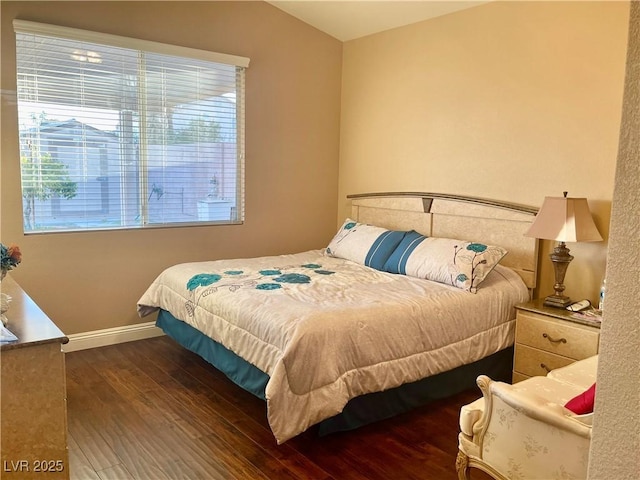 bedroom featuring dark wood-type flooring and vaulted ceiling