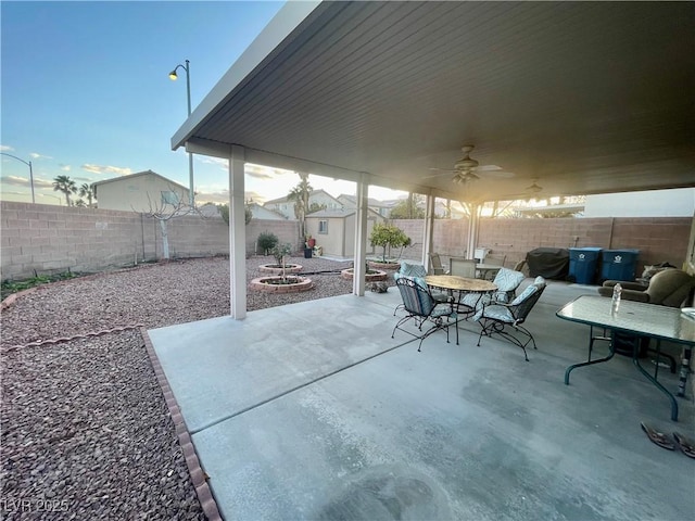 view of patio / terrace with area for grilling, ceiling fan, and a shed