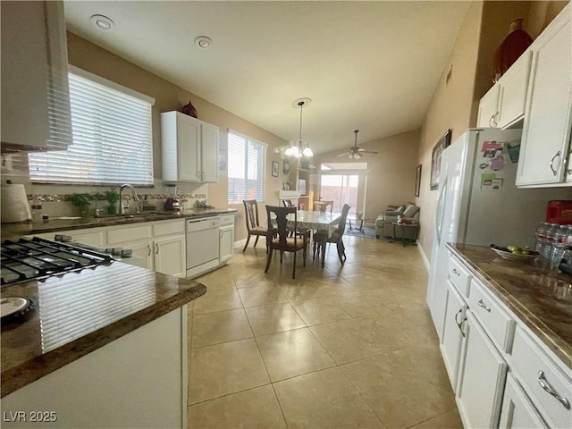 kitchen with white cabinetry, white dishwasher, sink, and hanging light fixtures