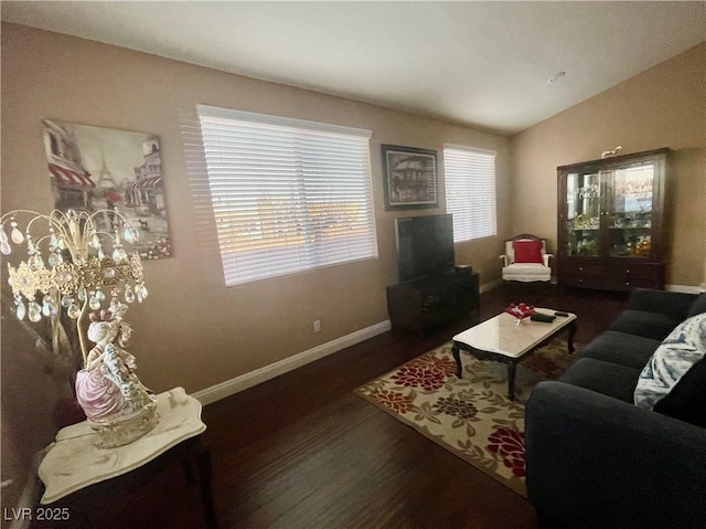 living room with dark hardwood / wood-style flooring and vaulted ceiling