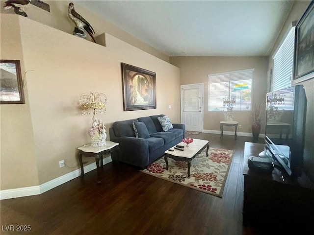 living room featuring dark hardwood / wood-style flooring and vaulted ceiling