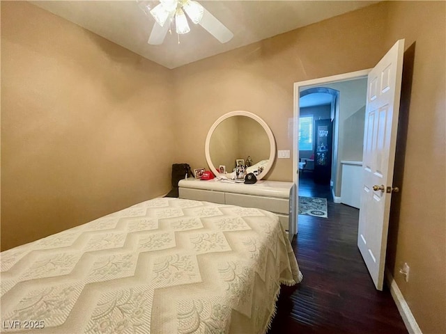 bedroom with ceiling fan and dark hardwood / wood-style flooring