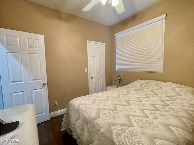 bedroom with dark hardwood / wood-style flooring and ceiling fan