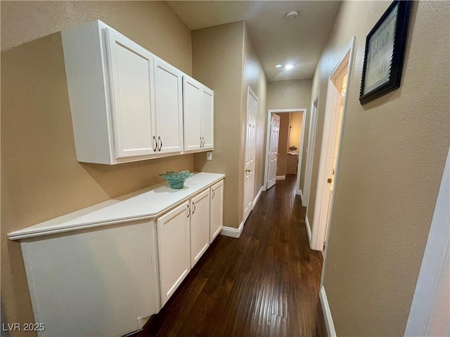 corridor featuring dark hardwood / wood-style floors