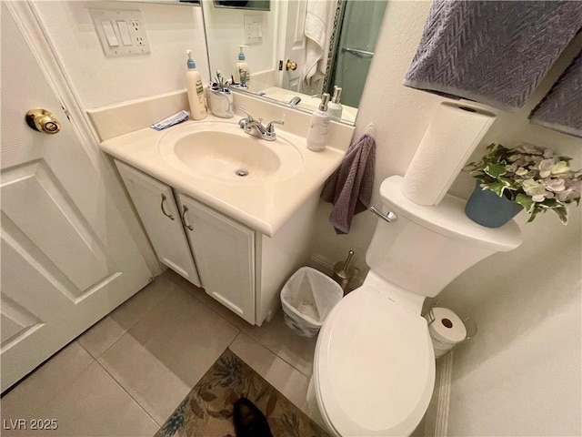 bathroom with vanity, tile patterned floors, and toilet