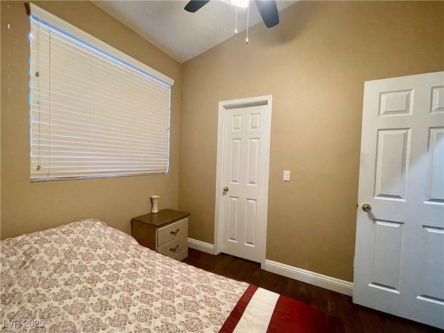 bedroom featuring ceiling fan, dark hardwood / wood-style floors, and vaulted ceiling