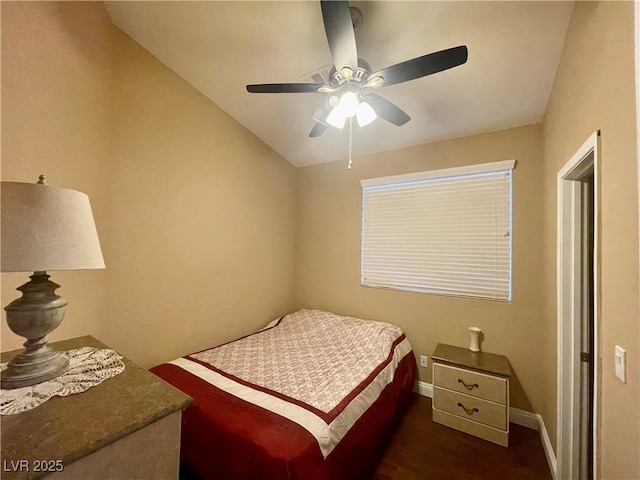 bedroom featuring ceiling fan, lofted ceiling, and dark hardwood / wood-style flooring