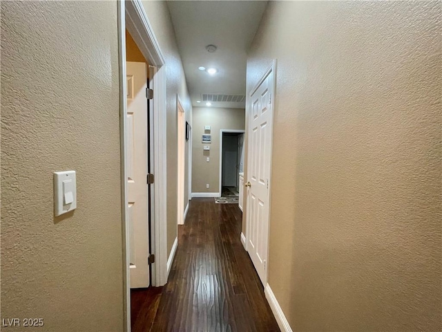 hall with dark wood-type flooring